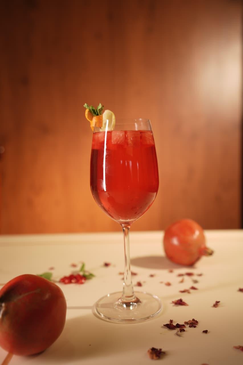 Pomegranate cooler in a wine glass garnished with mint
