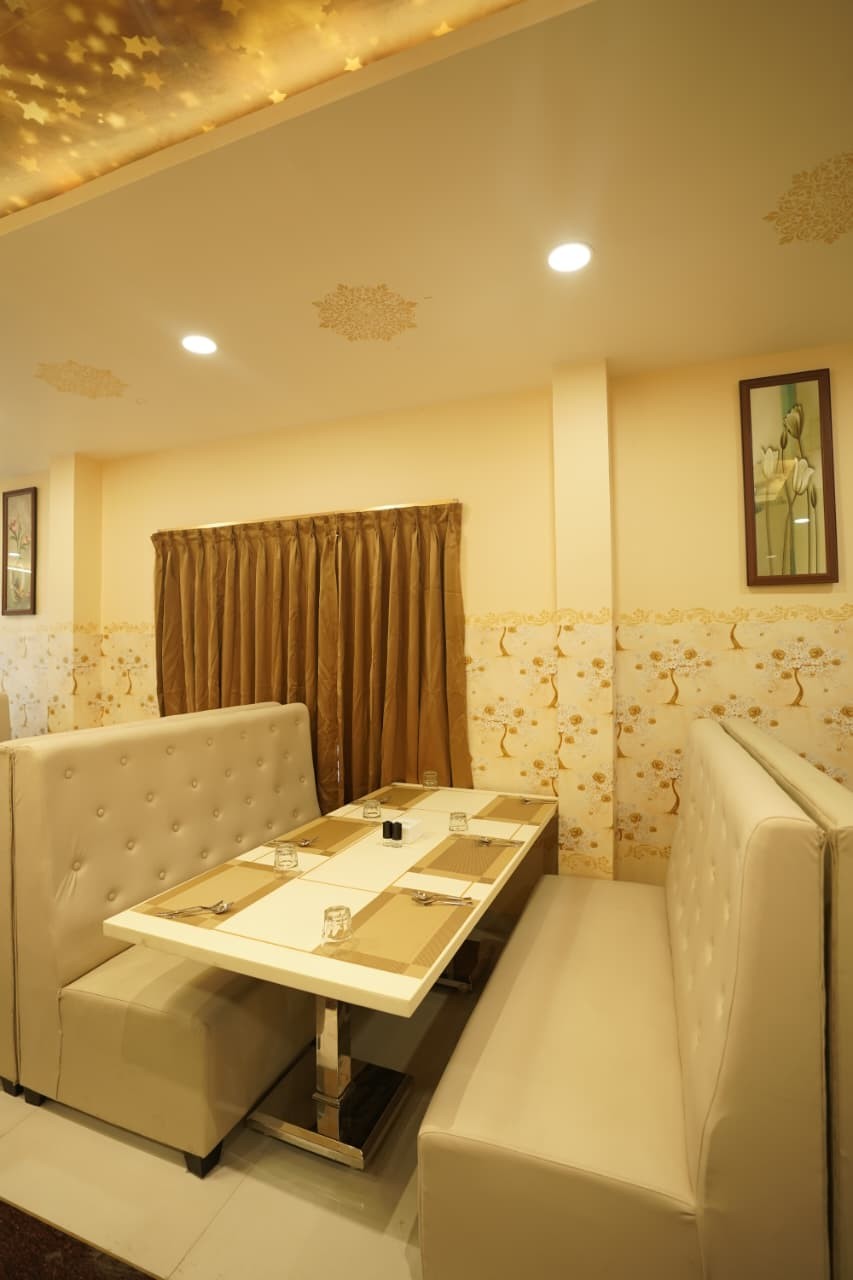 Ivory tufted booth beside a gold curtain