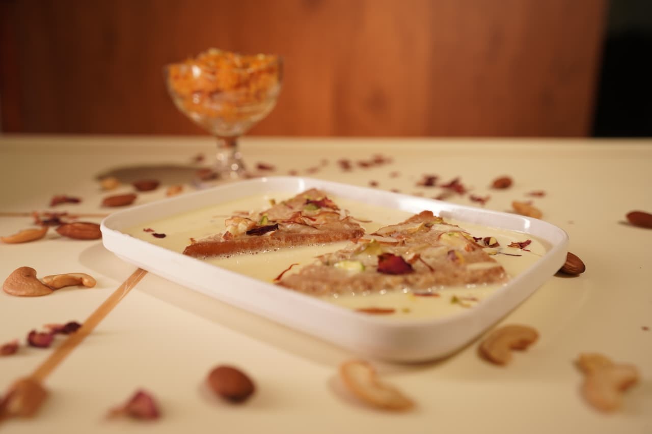 Shahi tukda topped with nuts and rose petals