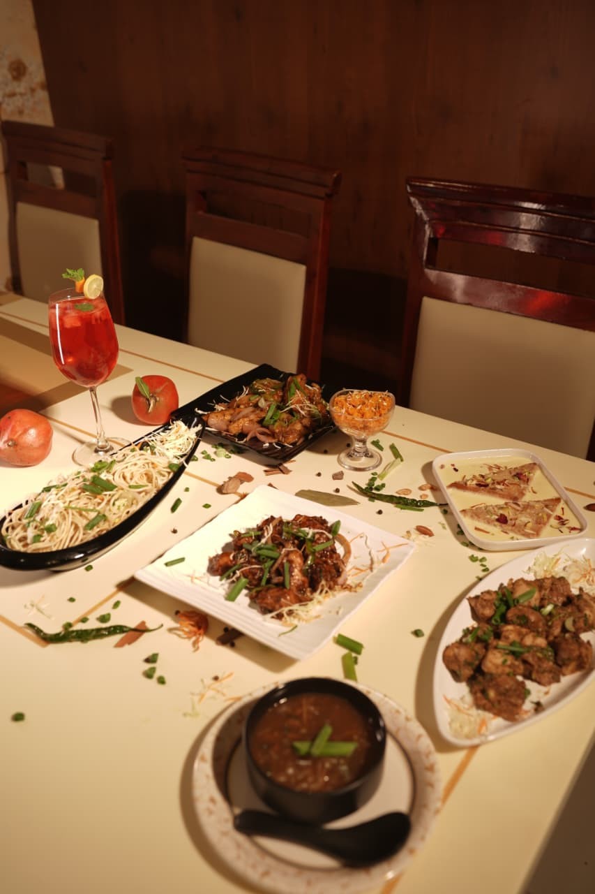 A shared spread of dishes laid out on a dining table